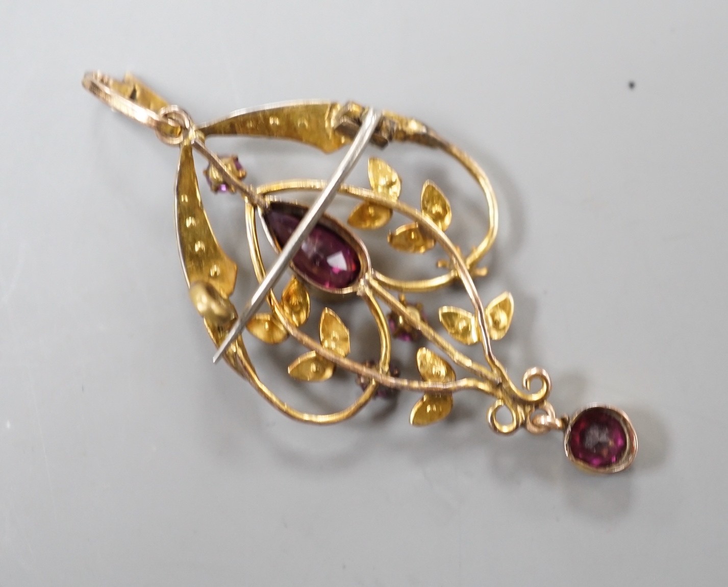 An Edwardian yellow metal, garnet, amethyst? and seed pearl set drop pendant, overall 51mm, gross weight 3.3 grams.